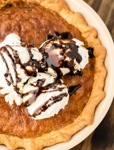 overhead view of a cookie pie piled with ice cream and fudge