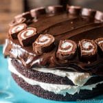 6 layers of homemade chocolate cake, fluffy white frosting and thick chocolate ganache make up this grown up ho ho cake. It's a grown-up version of your favorite lunch-room snack.