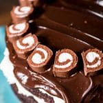 6 layers of homemade chocolate cake, fluffy white frosting and thick chocolate ganache make up this grown up ho ho cake. It's a grown-up version of your favorite lunch-room snack.