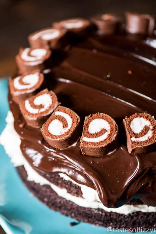 6 layers of homemade chocolate cake, fluffy white frosting and thick chocolate ganache make up this grown up ho ho cake. It's a grown-up version of your favorite lunch-room snack.