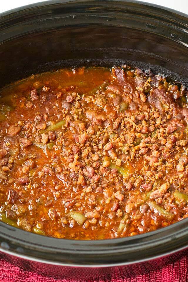 Throw this Slow Cooker Sausage Baked Bean Casserole together in the morning and forget it until your picnic. It's packed with bacon and 3 kinds of beans.