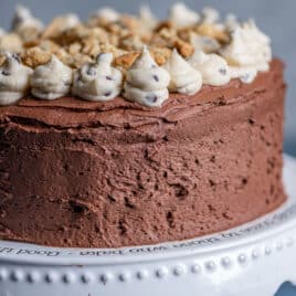 a cookie dough cake sitting on a cake plate