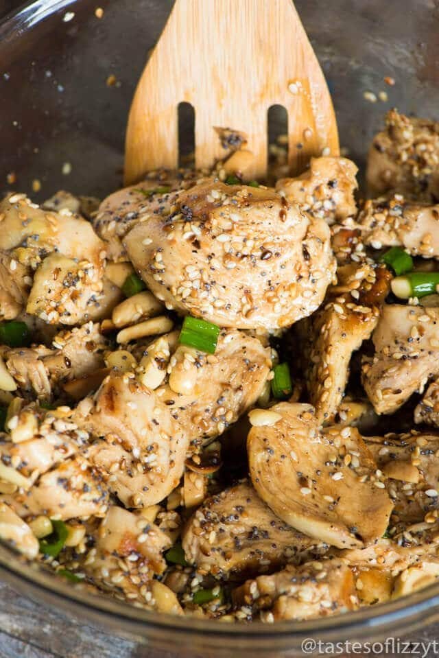 chicken and toasted seeds and nuts in a mixing bowl