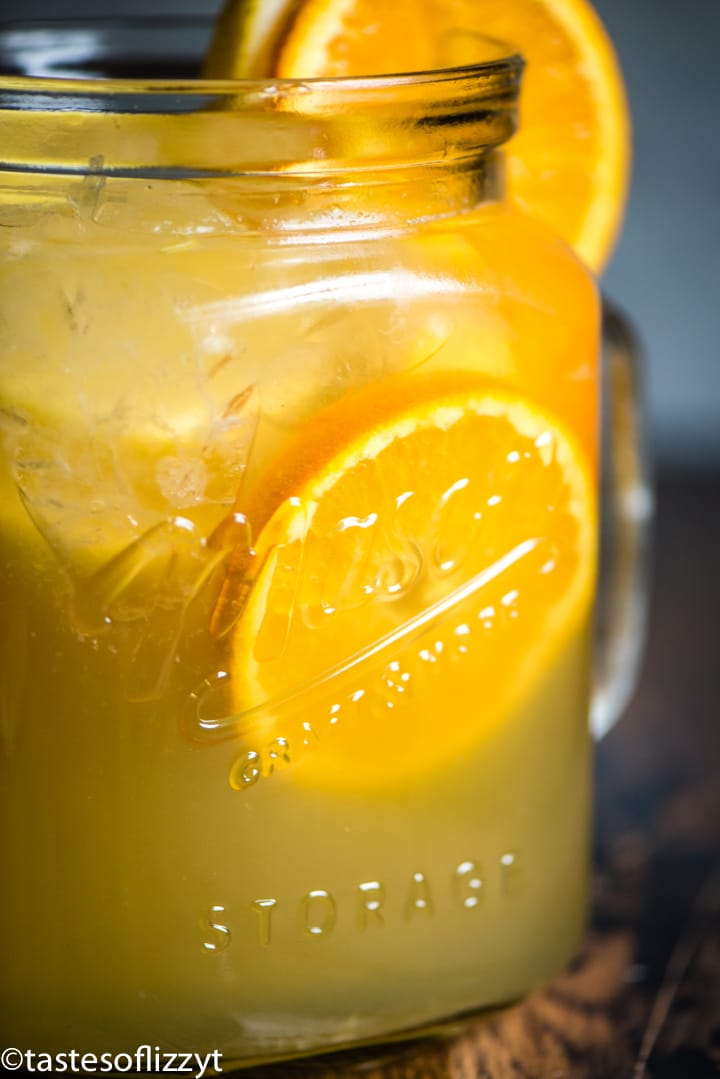 A glass of orange juice, with Punch and Fruit