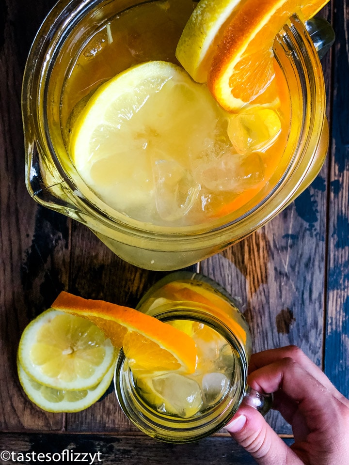a jar of fruit punch with orange and lemon slices