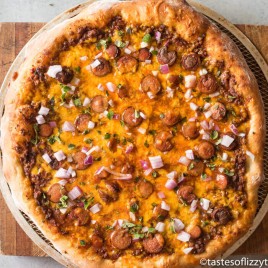 Take the classic chili cheese dog and twist it up with this Chili Cheese Pizza. Chili sauce, cheddar cheese, sliced hot dogs, and onion top a chewy pizza crust.