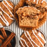 overhead view of muffins in a pan, one cut open