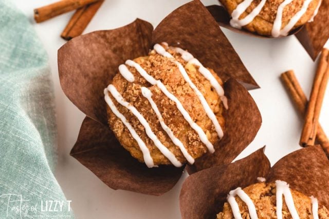 overhead view of a glazed cinnamon coffee cake muffin in a brown wrapper