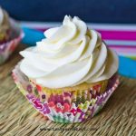 white cupcake with white frosting in flowered cupcake liner