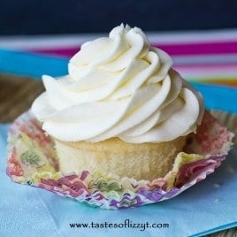 unwrapped white cupcake with white swirled frosting