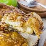 A slice of upside down apple dumpling pie with brown sugar nut syrup