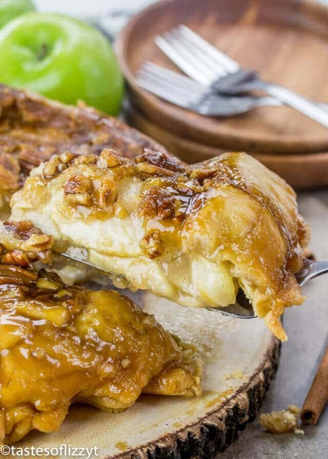 A slice of upside down apple dumpling pie with brown sugar nut syrup