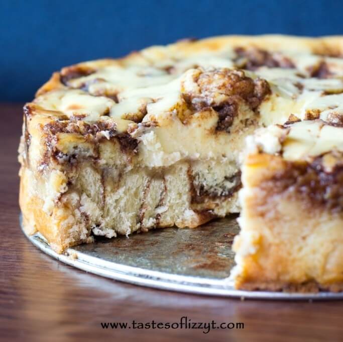 cinnamon roll cheesecake with a slice out of it