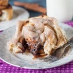 Gooey, homemade Apple Butter Cinnamon Rolls are filled with sweetened apple butter, baked to a soft, golden brown and spread with cinnamon cream cheese frosting.