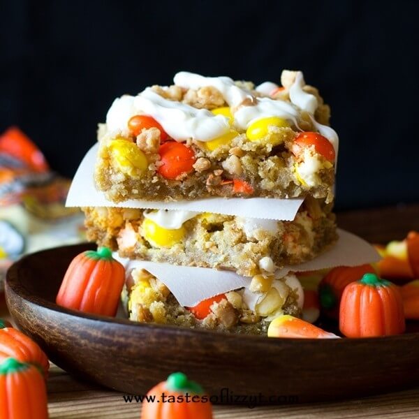 cookie bars with m&ms and white chocolate stacked on each other