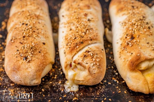 baked strombolis on a baking sheet