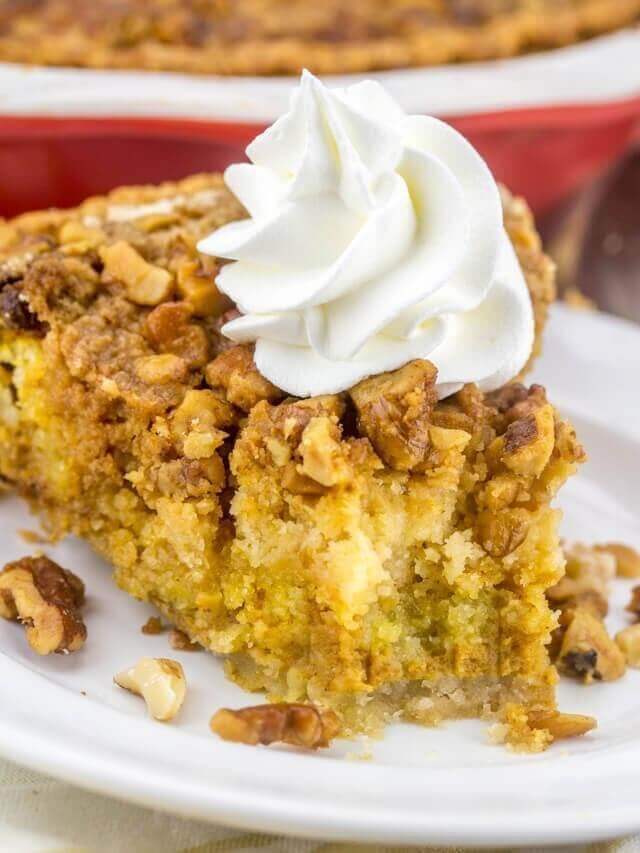 slice of pumpkin crumb pie with whipped cream on top