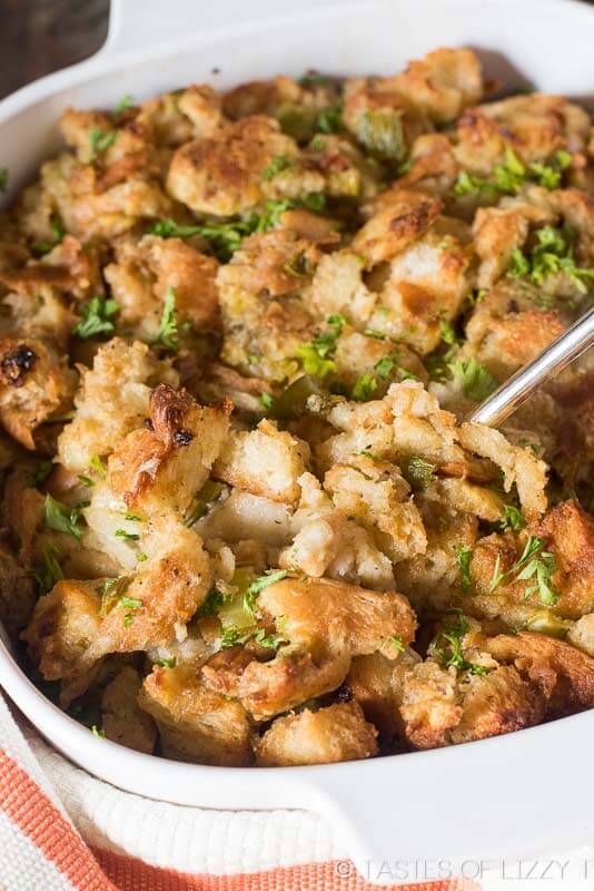 stuffing in a baking pan with a spoon