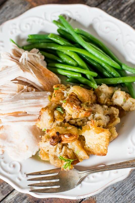 a plate of stuffing, turkey and green beans