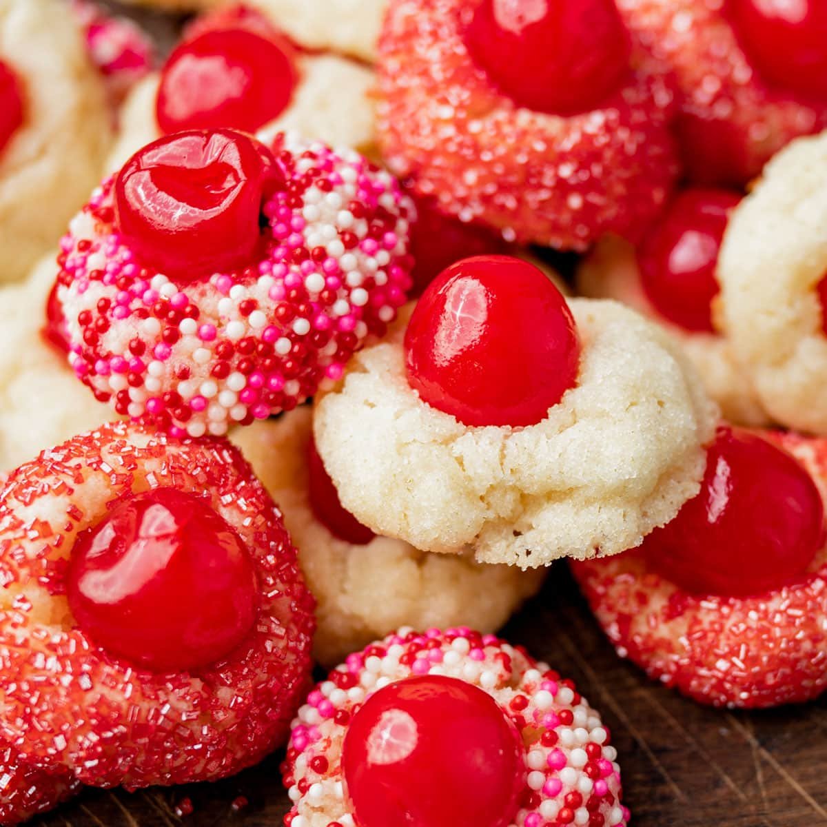 closeup of cream cheese cherry cookies in a pile