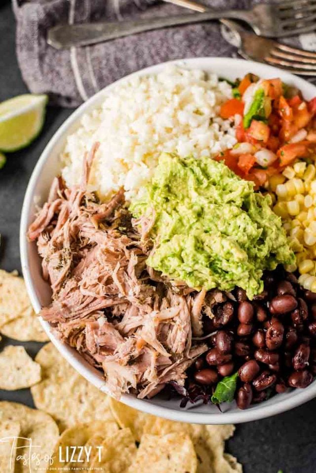 A plate of food with rice meat and vegetables, with Pork and Carnitas