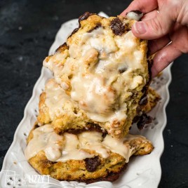 A person holding a piece of cinnamon scones