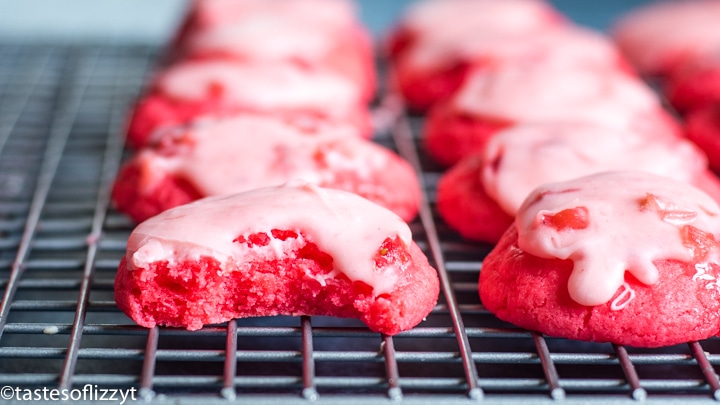 A close up of strawberry cookies on a wire rack