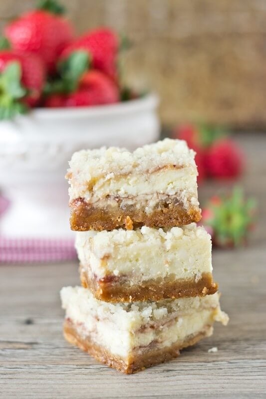 Strawberry Shortcake Cheesecake Bars. Golden Oreo crust, strawberries swirled in the cheesecake and an amazing streusel on top. Serve with strawberries and whipped cream!