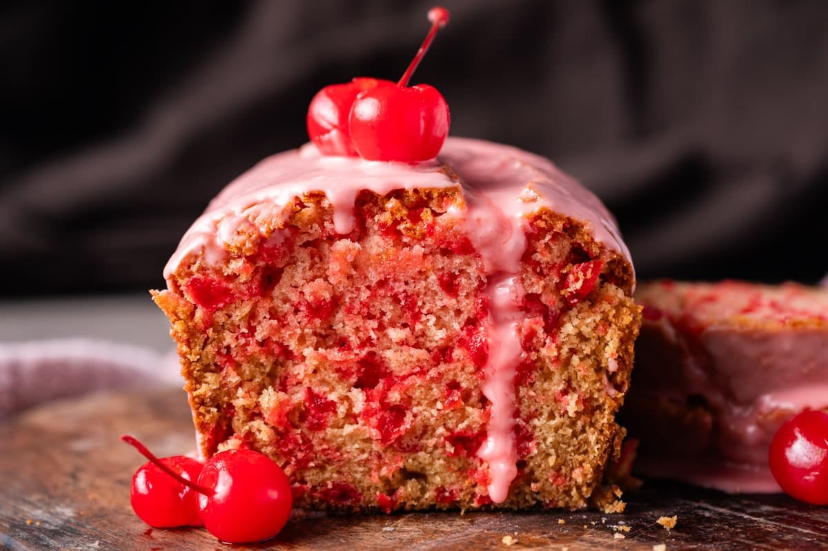 half of a loaf of cherry bread on a table