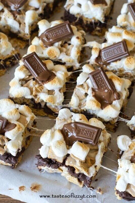 S'more Brownie Batter Bars. Gooey bars with brownie batter sandwiched between marshmallow covered golden grahams and toasted marshmallows on top!