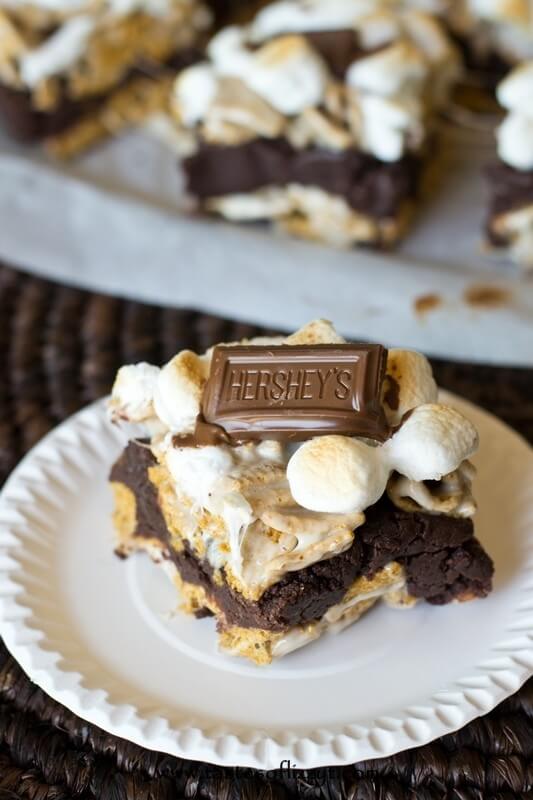 S'more Brownie Batter Bars. Gooey bars with brownie batter sandwiched between marshmallow covered golden grahams and toasted marshmallows on top!