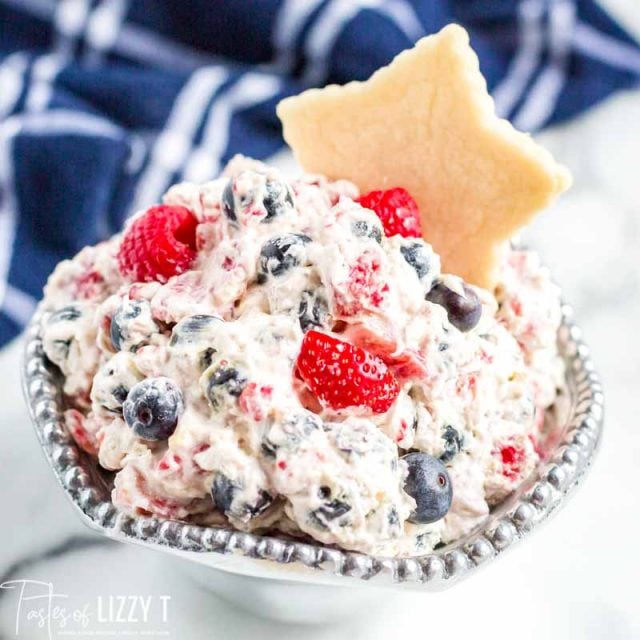 bowl of triple berry fruit dip with a star cut out cookie