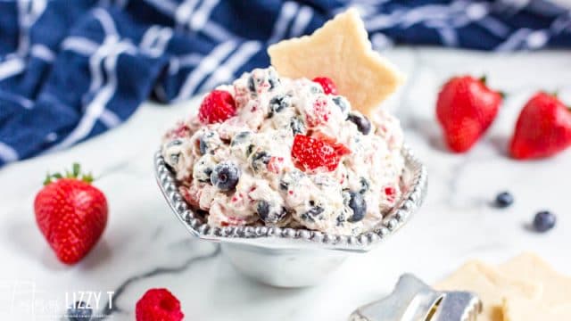 silver bowl of berry fruit dip with a star cookie in it