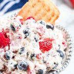 bowl of triple berry fruit dip with shortbread cookie