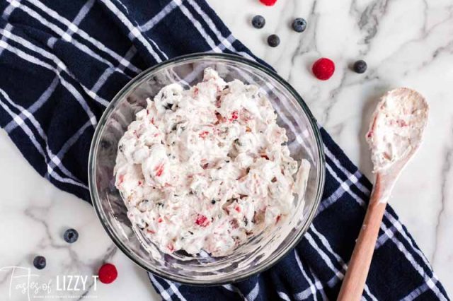 whipped cream and berries mixed in a bowl