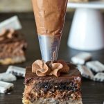 Cookies 'n Cream Cheesecake Bars with frosting piping on top