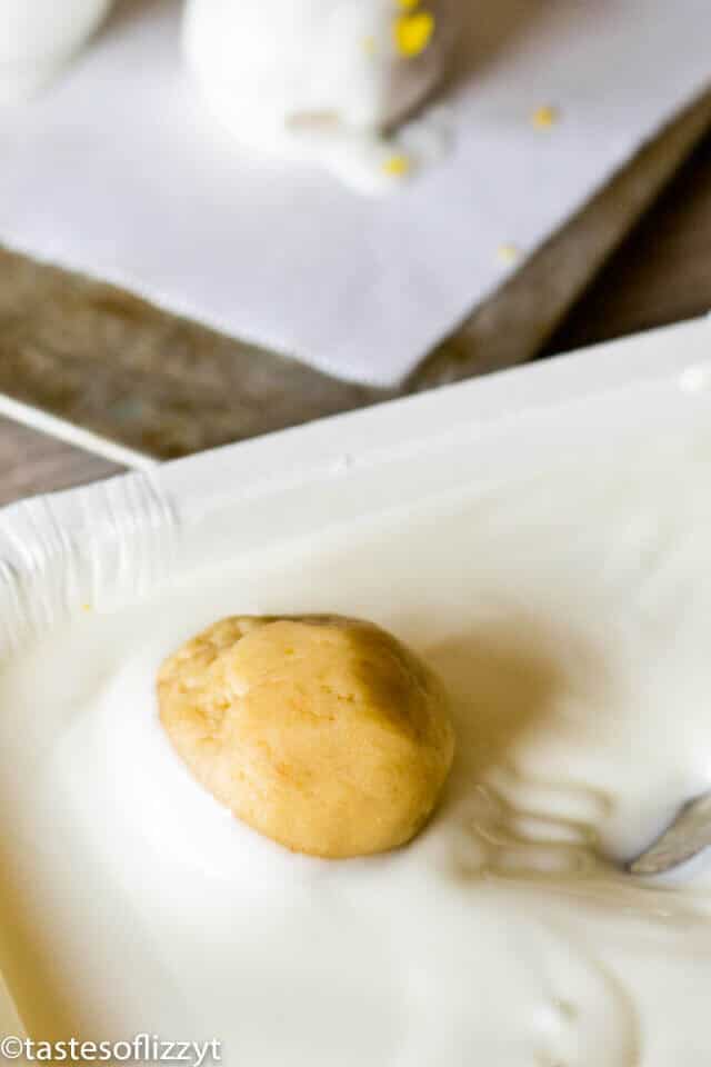 Orange Creamsicles made from vanilla wafers being dipped in white chocolate.