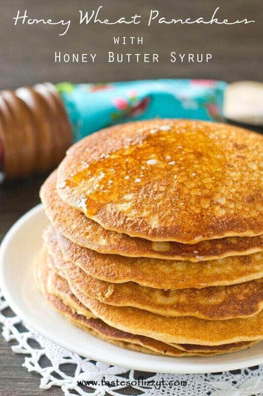 A stack of pancakes on a plate, with Honey and Butter
