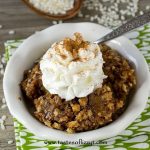 pumpkin pie rice pudding in a bowl with whipped cream