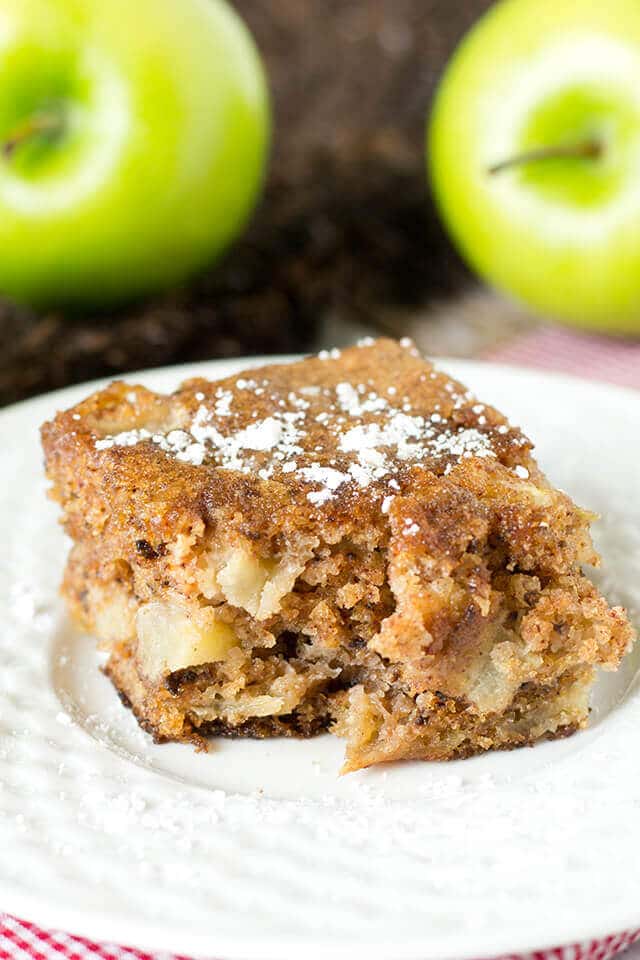 slice of moist cinnamon snack cake with apples and walnuts