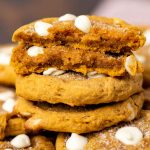 stack of pumpkin cookies, one broken in half