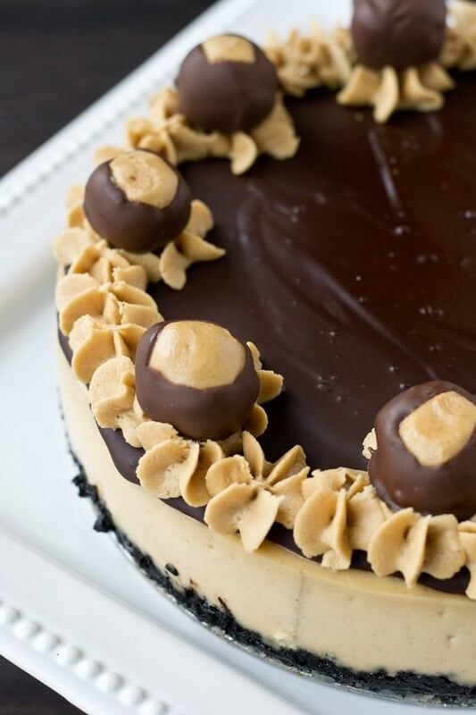 Rich, creamy peanut butter cheesecake topped with sweet chocolate ganache and and an Oreo cookie crust.