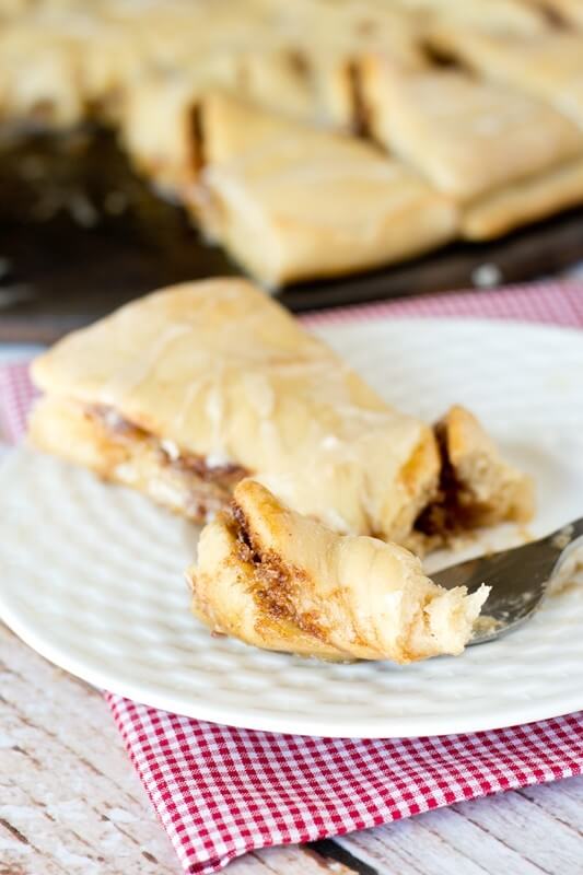 Impress your friends with these Maple Nut Cinnamon Twists. Sweet dough is filled with a brown sugar, cinnamon-nut spread and drizzled with maple glaze. 