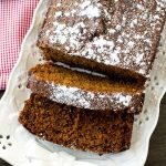 overhead view of powdered sugar topped gingerbread loaf