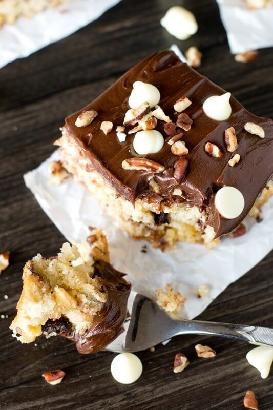 Cookie batter cake is full of white chocolate, semi-sweet chocolate chips, nuts and topped with chocolate frosting. Kids and adults will love this Chocolate Chip Cookie Cake!