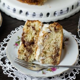cream filled cinnamon cake on a plate
