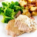 Paleo Slow Cooker Pork Chops on a plate with potatoes and broccoli