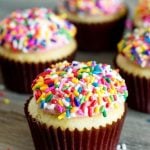 white cream cupcakes with sprinkles