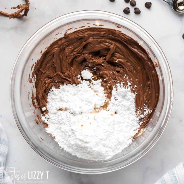 nutella and butter with powdered sugar in a mixing bowl