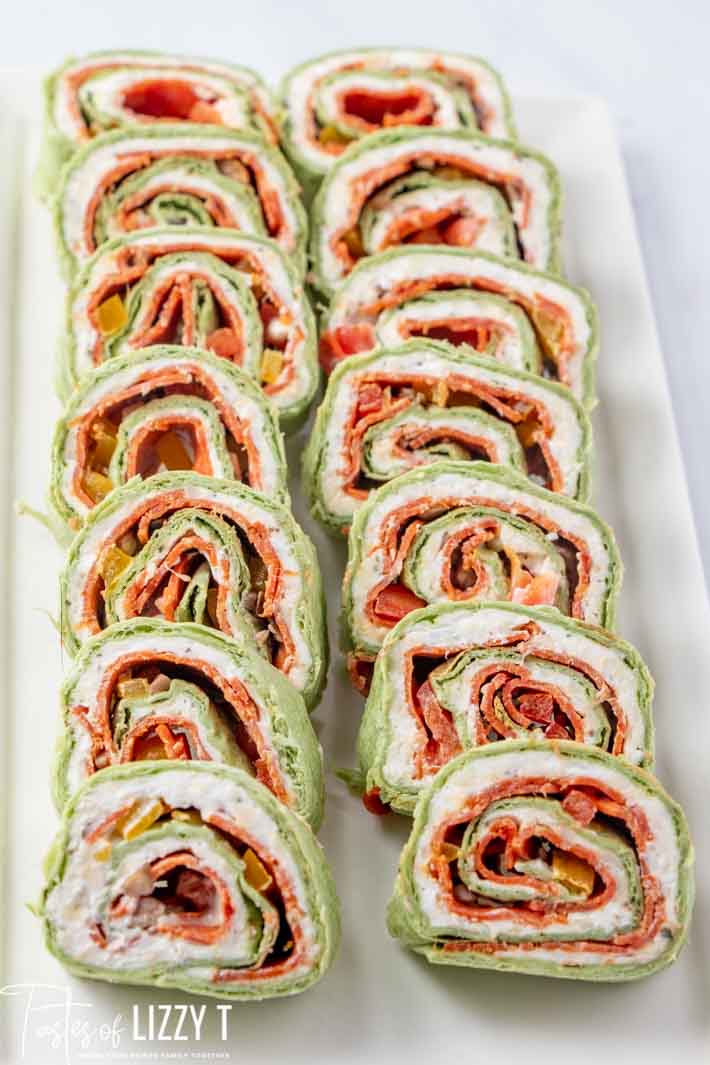 A close up of a tray of pepperoni rollups